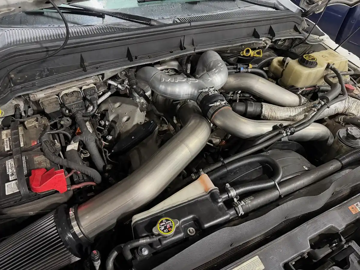 Diesel pickup truck engine bay during performance service at Bergen Diesel